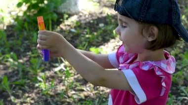 Kırmızı elbiseli ve beysbol şapkalı şirin bir kız. Kıpır kıpır pop çalıyor. Yumuşak, yumuşak, yumuşak oyuncaklarla oynuyor.
