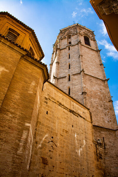 Valencia Spain. May 18, 2021 - Bell tower of the Valencia Cathedral, known as Miguelete, from the base on the street. Valencian Gothic style, built in 1429. A must for tourists