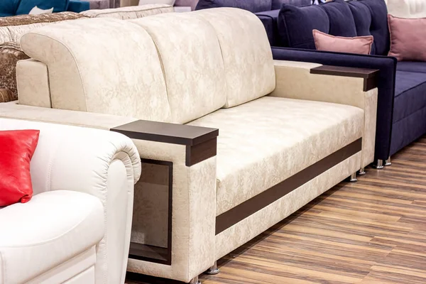 Big comfortable beige sofa in the luxury furniture store.
