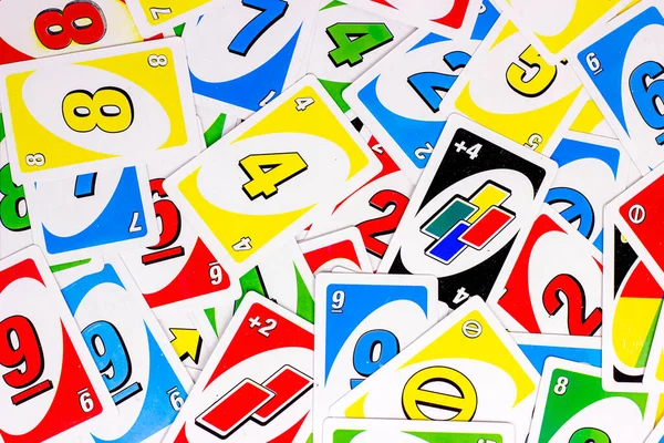 Deck of Uno Game Cards Scattered All Over on a Table. American