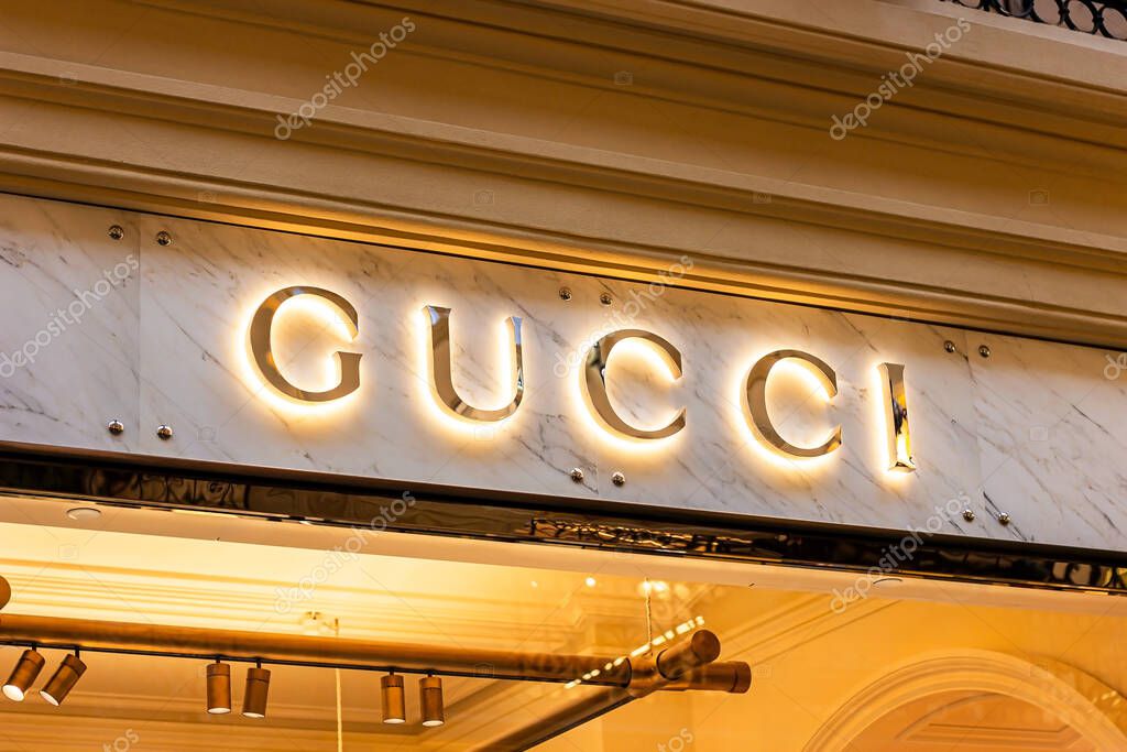 MOSCOW, RUSSIA - AUGUST 10, 2021: Gucci retail shop logo singboard on the storefront in the shopping mall.