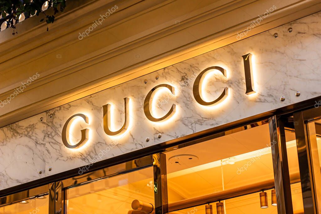 MOSCOW, RUSSIA - AUGUST 10, 2021: Gucci retail shop logo singboard on the storefront in the shopping mall.
