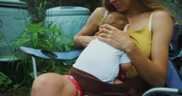 Mother Feeding Her Baby Boy While Sitting Garden Chair — Stockvideo