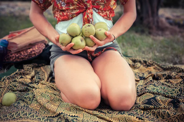 Junge Frau draußen mit Äpfeln — Stockfoto