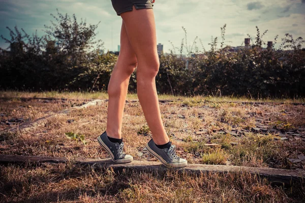 Young woman walking on her tip toes — Stock Photo, Image