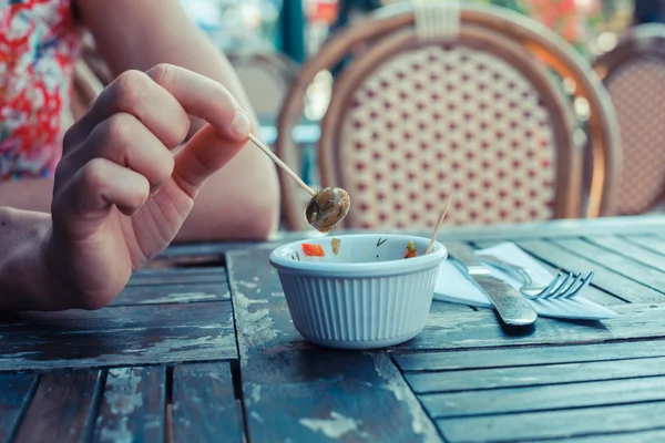 Woman eating olives outside — Stock Photo, Image