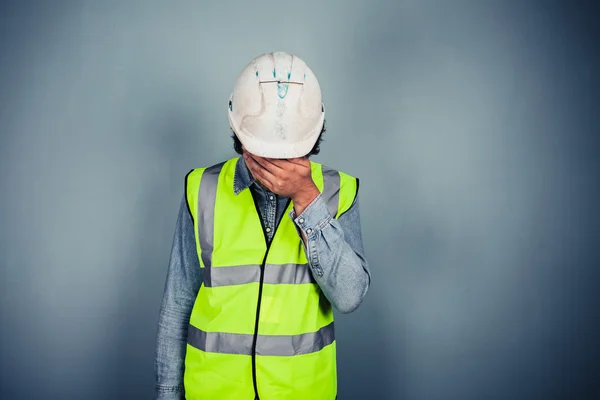 Engineer in high vis covering face — Stock Photo, Image