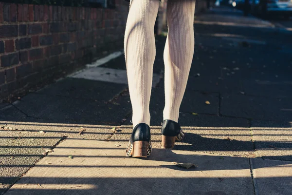 Les jambes d'une femme marchant dans la rue — Photo