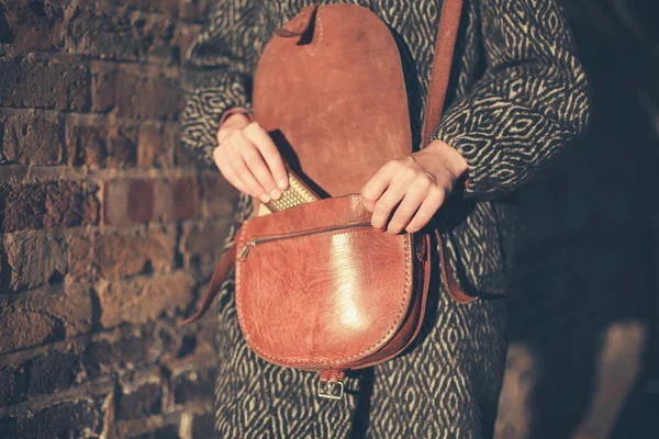 Woman getting phone from bag — Stock Photo, Image