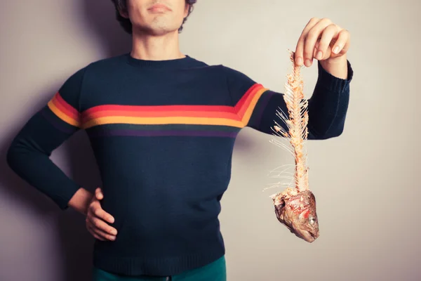 Man with fish skeleton — Stock Photo, Image