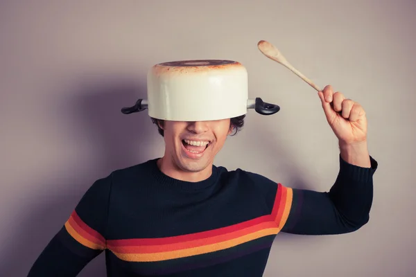 Silly young man with pot on his head — Stock Photo, Image