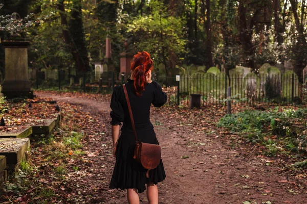 Woman on phone in cemetery — Stock Photo, Image