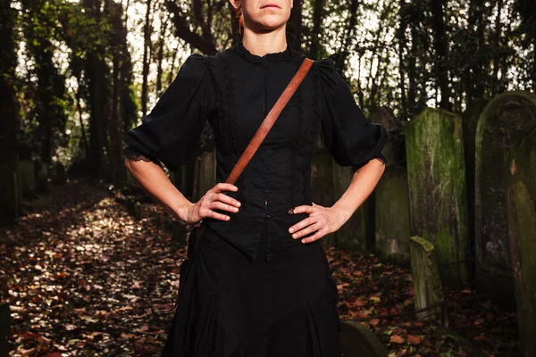 Woman walking amongst tombstones — Stock Photo, Image