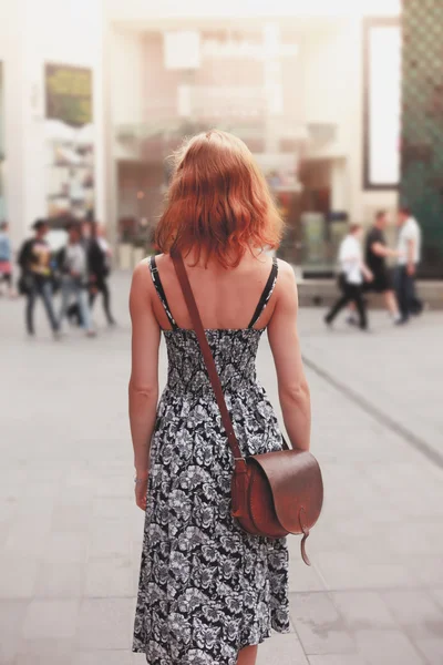 Jonge vrouw lopen in de straat — Stockfoto