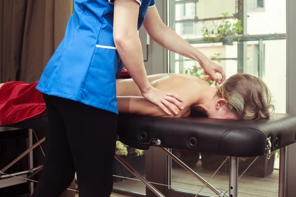 Woman being massaged on a table — Stock Photo, Image