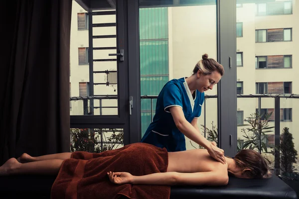 Massage therapist treating patient at home — Stock Photo, Image