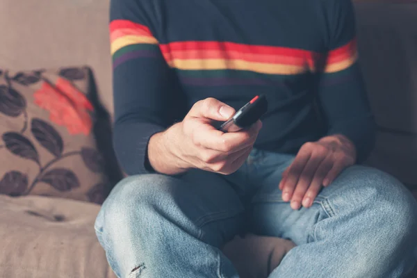 Young man changing channel — Stock Photo, Image