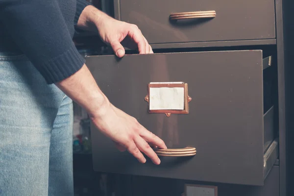 Man opening file cabinet — Stock Photo, Image