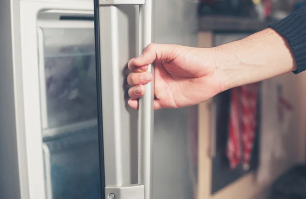 Hand opening freezer door — Stock Photo, Image