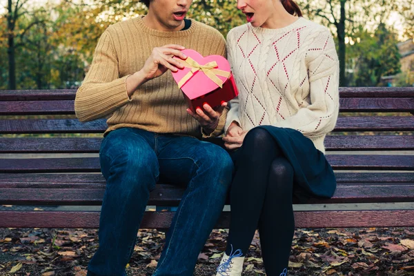 Couple opening heart shaped box — Stock Photo, Image