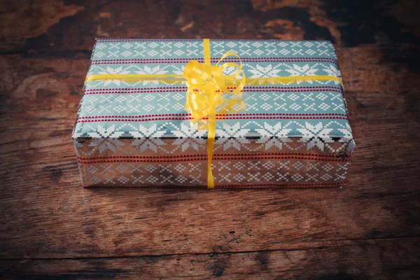 Present on a wooden table — Stock Photo, Image