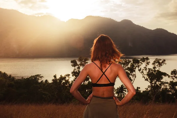Giovane donna ammirando il tramonto sulla baia — Foto Stock