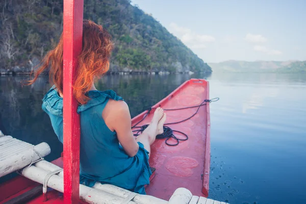 Kvinne på baugen i en liten båt – stockfoto