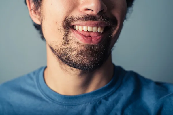 Jovem homem puxando rostos — Fotografia de Stock