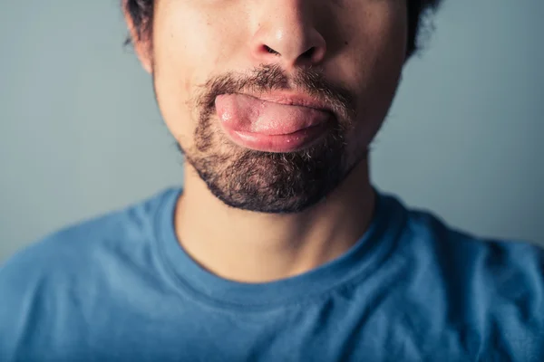 Young man pulling faces — Stock Photo, Image