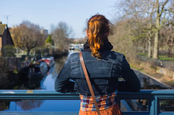 Donna che guarda il canale dal ponte — Foto Stock