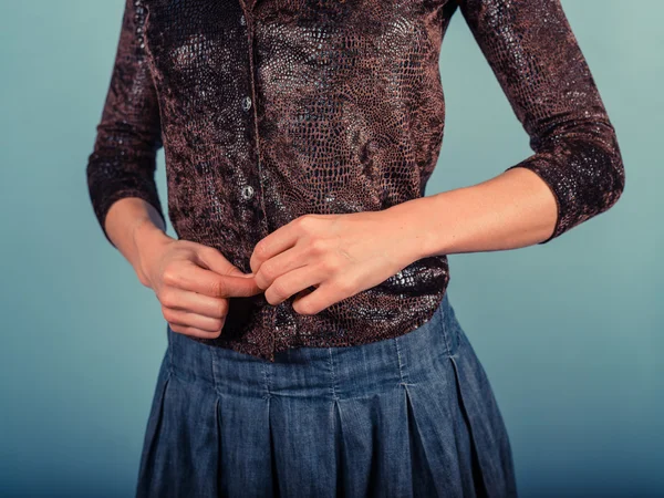 Woman buttoning her shirt — Stock Photo, Image