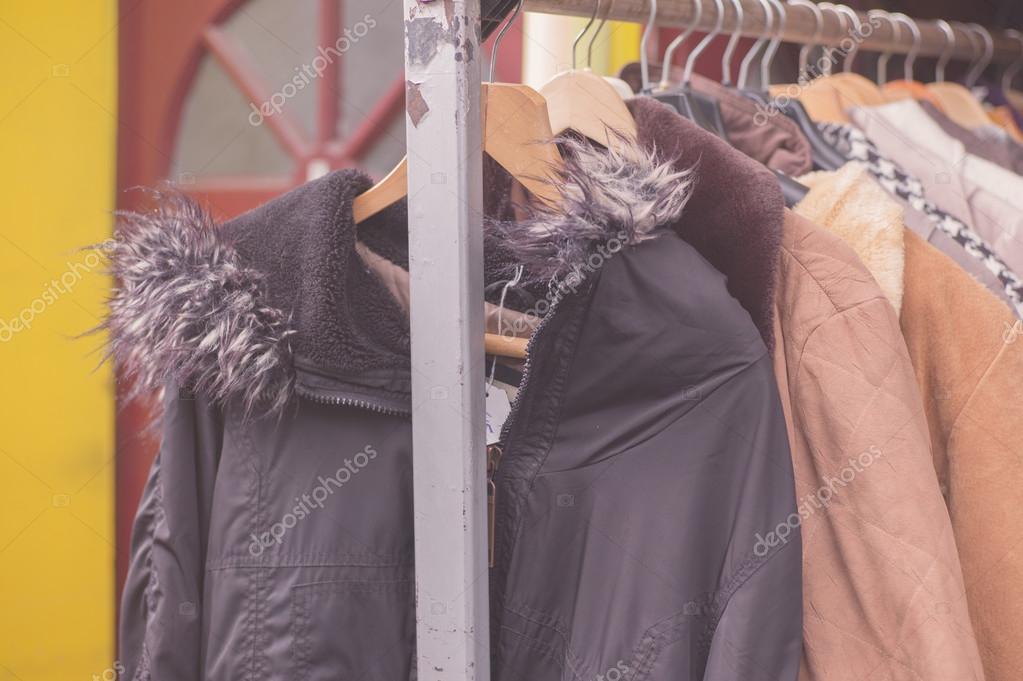 Winter jackets hanging on rail outside — Stock Photo © lofilolo #69952901