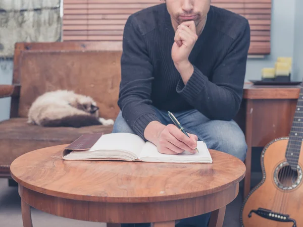 Young songwriter sitting on sofa at home — Stock Photo, Image