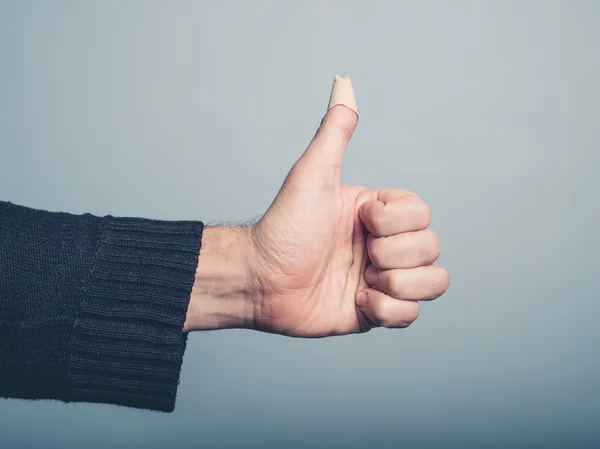 Wounded thumbs up with plaster — Stock Photo, Image