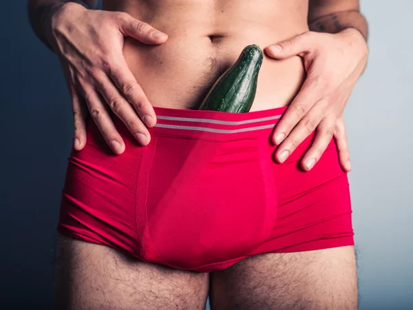 Young man with cucumber in his underpants — Stock Photo, Image