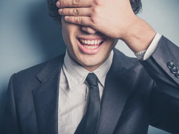 Happy businessman covering his face — Stock Photo, Image