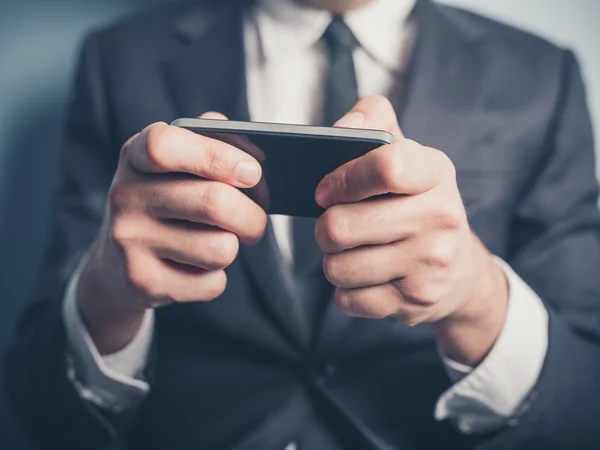 Close up on businessman using smartphone — Stock Photo, Image