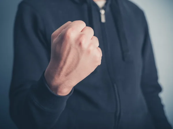 Young man raising his fist — Stock Photo, Image