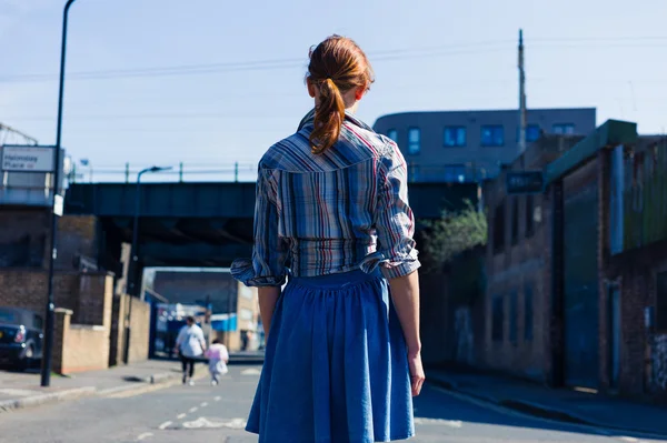 Woman walking in the street near trainline — Stock Photo, Image