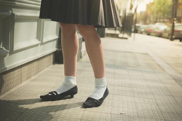 Woman in skirt walking the street — Stock Photo, Image