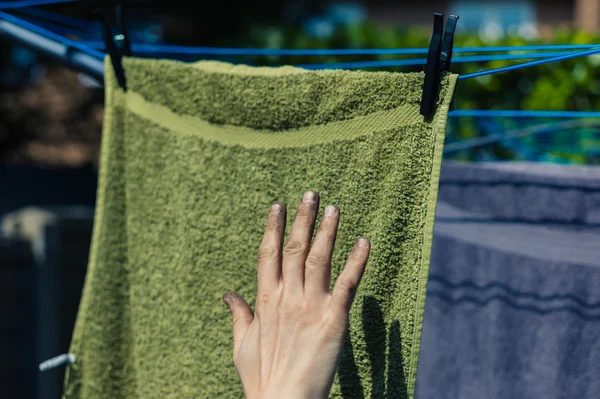 Dirty hand touching clean laundry — Stock Photo, Image