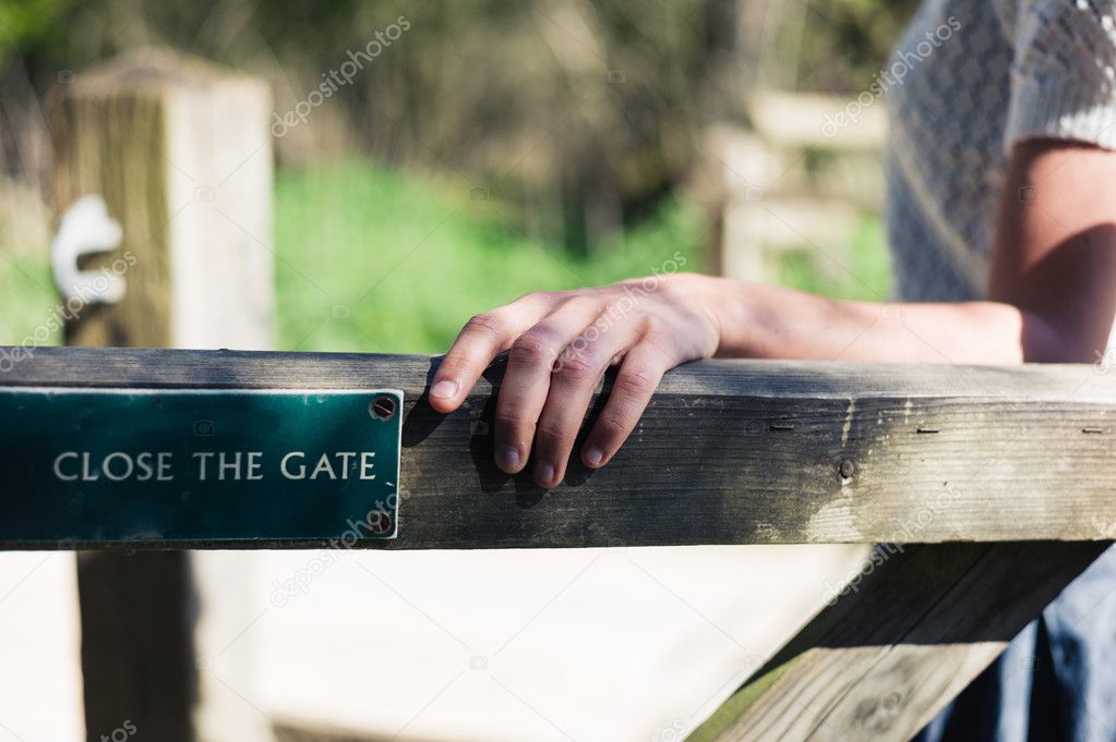 Woman opening gate in forest