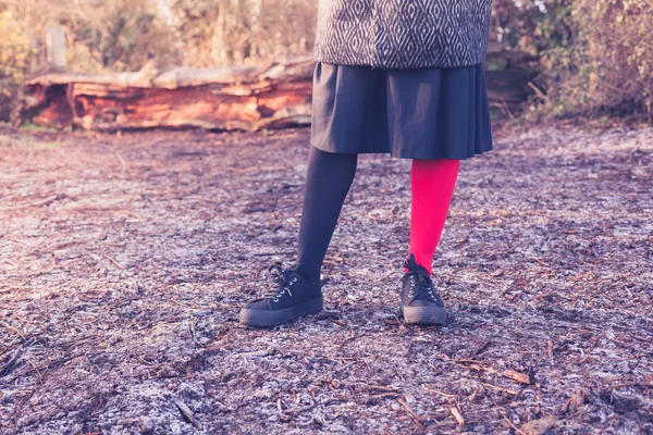 Woman wearing odd leggings on frosty ground — Stock Photo, Image