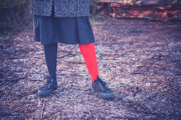 Woman wearing odd leggings on frosty ground — Stock Photo, Image