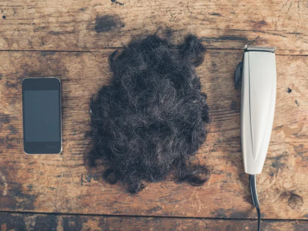 Phone, hair and clippers — Stock Photo, Image