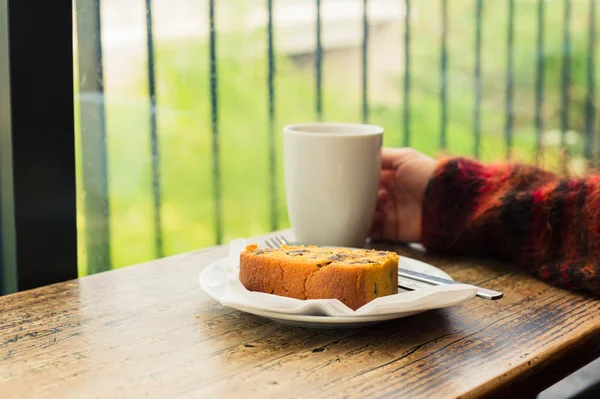 Tea and cake by the window — Stock Photo, Image