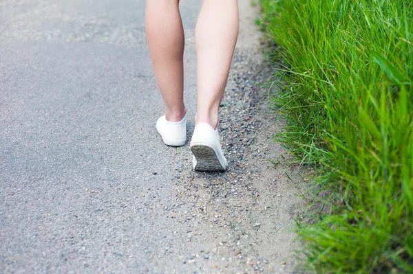 Mulher andando na estrada no país — Fotografia de Stock