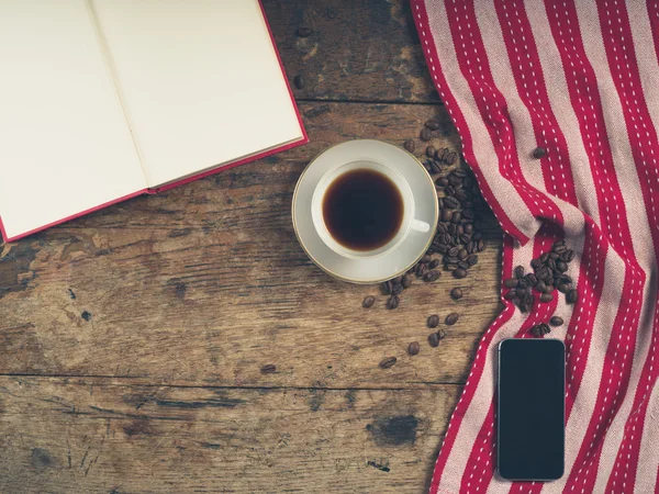 Kupası, bir kitap ve bir akıllı telefon ile kahve kavramı — Stok fotoğraf