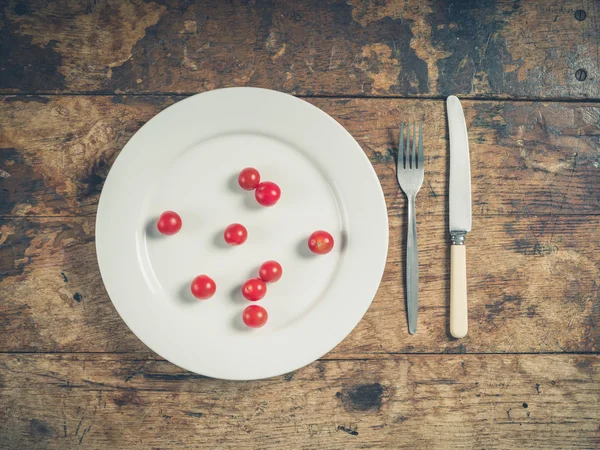 Plate with cherry tomatoes — Stock Photo, Image