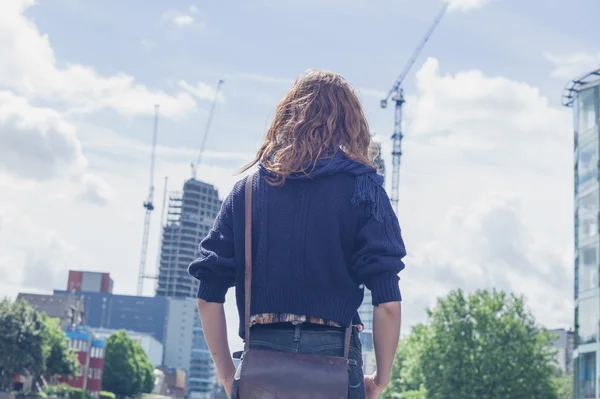 Woman looking at building works — Stock Photo, Image